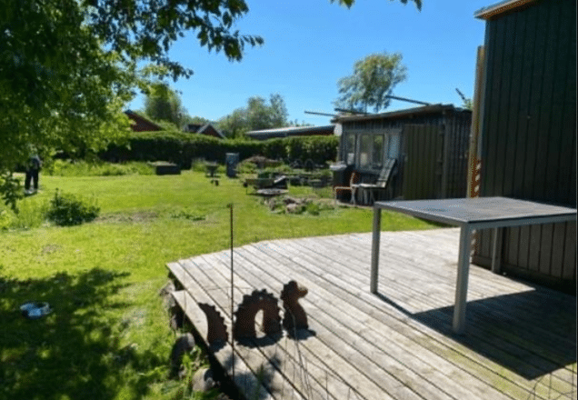 Idyllisk kolonihave med grønne områder og træterrasse i Randers.